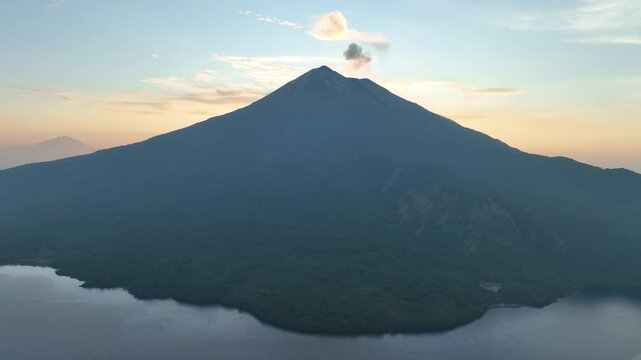 Sunset illuminates the peak of Iliape volcano on Lembata Island in the Lesser Sunda Islands of Indonesia. This scenic volcano in the ring of fire has been extremely active since 2024.