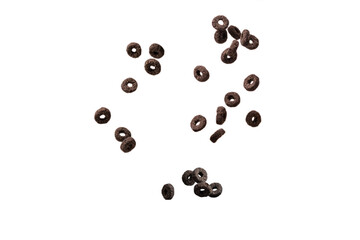 Chocolate rings cereal spill out into a bowl. Breakfast.