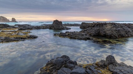 Sunset with rocky foreshore at low tide.