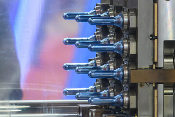 Close up scene of injection process group of preform shape of PET bottle products.