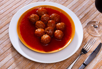 Appetizing dish of meatballs with tomato sauce served on platter
