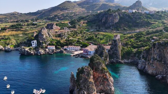 Il mare della Sicilia, Italia. Tonnara di Scopello. 4K
Vista aerea della costa pi&ugrave; bella della Sicilia. La baia di Scopello, tra Palermo e San Vito Lo Capo. Riserva dello Zingaro. 