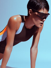 Obraz premium Athletic young Asian woman in sportswear and sunglasses preparing for physical exercises during a workout. Concept of sport and health.