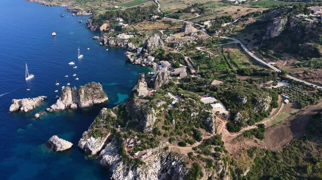 Il mare della Sicilia, Italia. Tonnara di Scopello. 4K
Vista aerea della costa pi&ugrave; bella della Sicilia. La baia di Scopello, tra Palermo e San Vito Lo Capo. Riserva dello Zingaro. 
