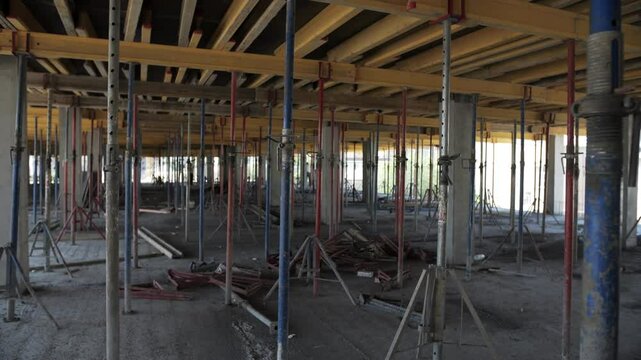 Concrete floor under construction with formwork and support props