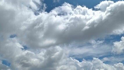 Fototapeta premium Stunning View of Cumulus Clouds Drifting Across a Vivid Blue Sky A Breathtaking Nature Photography