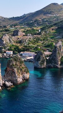 Il mare della Sicilia, Italia. Tonnara di Scopello. 4K
Vista aerea della costa pi&ugrave; bella della Sicilia. La baia di Scopello, tra Palermo e San Vito Lo Capo. Riserva dello Zingaro. 