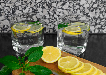 Glasses filled with mineral water with lemon and mint
