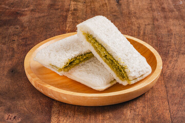 Matcha butter cream with white chocolate chip toast on wooden plate 