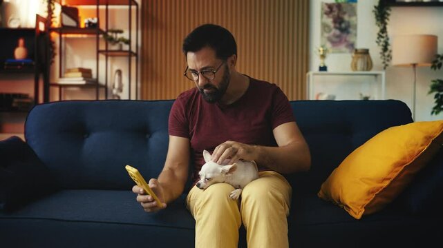 Caring pet owner with Chihuahua dog on lap, choosing pet toys on smartphone app