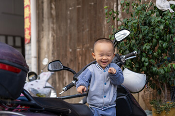 little boy riding on the motorcycle