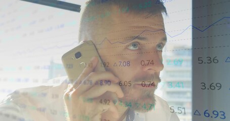 Businessman answering smartphone call analyzing overlaid financial charts for investment planning - Powered by Adobe