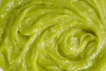 Close-up macro wasabi texture,Wasabi sauce texture background,top view,Bright green grated horseraddish wasabi spicy sauce texture circle rotation close up top view.