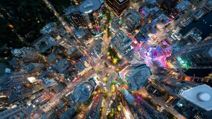 Drone ascends above neon-lit intersection of futuristic city - Powered by Adobe