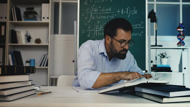 Male mathematician working on theoretical research, reading scientific books