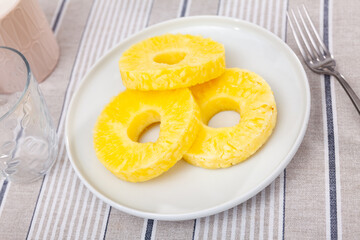 Sliced sweet juicy pineapple fruits served on platter