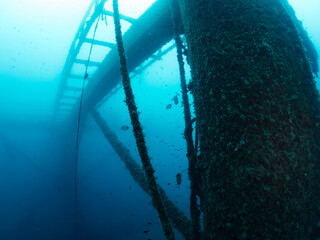 wreck of the submerged structure of an abandoned fish farm sunk in the sea, concept of scuba diving...