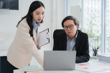 Business Colleagues Working Together on Laptop