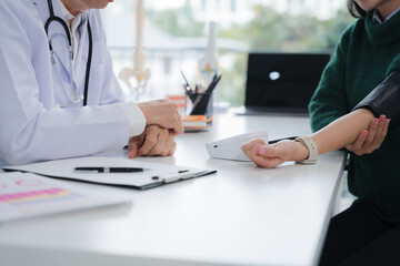 Doctor Measuring Patient's Blood Pressure
