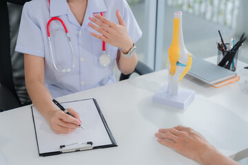 Doctor Explaining Knee Joint Anatomy to Patient