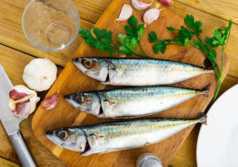 Delicious raw sardine with herbs on kitchen board