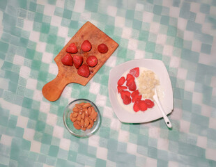 Healthy Breakfast with Yogurt, Fresh Strawberries, and Almonds on Rustic Wooden Board