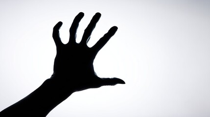 Obraz premium Shadowy hand reaching out against bright stark white background Dramatic and eerie
