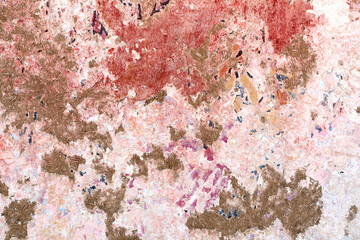 Naklejka premium old adobe wall with peeling paint in different colors