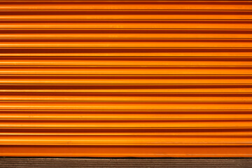 Orange colored shutters that protect warehouses and shops from environmental conditions and ensure their safety