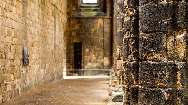 Weathered textures of stone column in historic Kirkstall Abbey, emphasizing passage of time and architectural detail