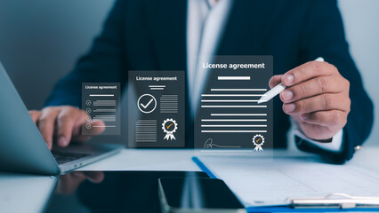 license agreement, Businessman uses a stylus to interact with documents, featuring digital...