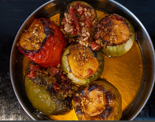 top view photo of a pan with stuffed peppers  with rice inside a cooking pan. Greek traditional food.