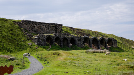 Old abandoned industrial mining kilns now lie empty and attract sheep for grazing in the North York Moors National Park