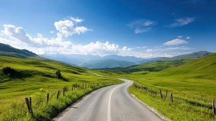 A picturesque view of a winding road surrounded by rolling green hills and majestic mountains, inviting travelers to embrace nature’s beauty and adventure.