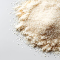 A mound of finely shredded, off-white rice, scattered on a light gray surface
