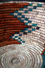 A Native American woven bowl with earth tones.