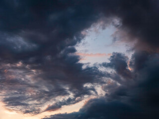 Dramatic gap in a dark cloud at sunset in southwest Florida, for background or element with motifs of air currents, changeability in nature, transitions and transformation