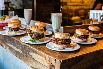 Row of burgers and milkshakes at a restaurant counter