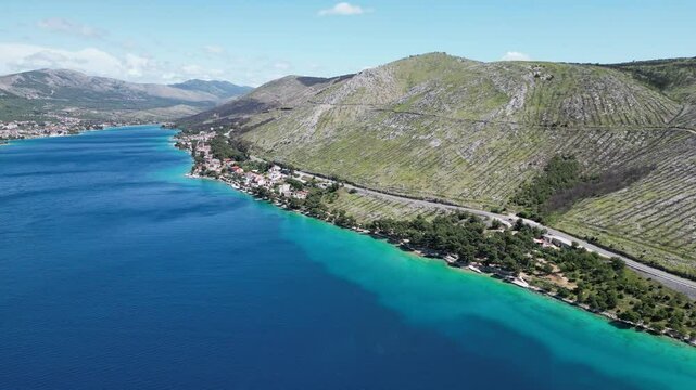 Family waving and then Aerial view of the Croatian coast with small campsites in the bay of Greba&scaron;tica close to Primosten in Dalmatia
