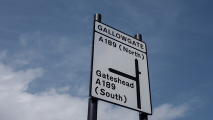 Road sign indicating Gallowgate - North - and Gateshead - South - on the A189 road in Newcastle, UK, under a cloudy sky