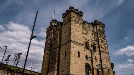 The imposing keep of Newcastle Castle standing tall against a backdrop of dramatic clouds in Newcastle upon Tyne, UK