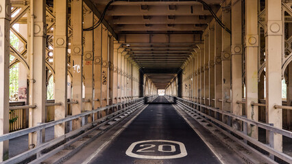 Empty road under Tyne Bridge in Newcastle upon Tyne, England, with speed limit sign