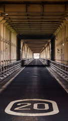 Road going under Tyne Bridge in Newcastle upon Tyne, UK, showing a speed limit sign