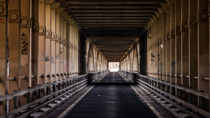 Dark asphalt road passing under Tyne Bridge in Newcastle upon Tyne, England, United Kingdom