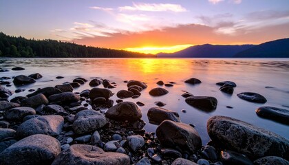 Obraz premium Sunset over the mountain and stones in lake 
