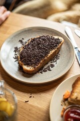 Hand holding a gourmet cheeseburger at a kitchen counter