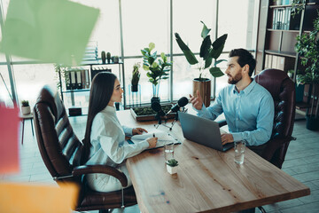 Dynamic business meeting between professionals in a modern coworking office discussing...