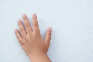 The boy is gesturing on a white background.