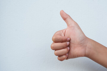 The boy is gesturing on a white background.