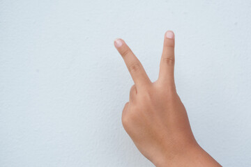 The boy is gesturing on a white background.